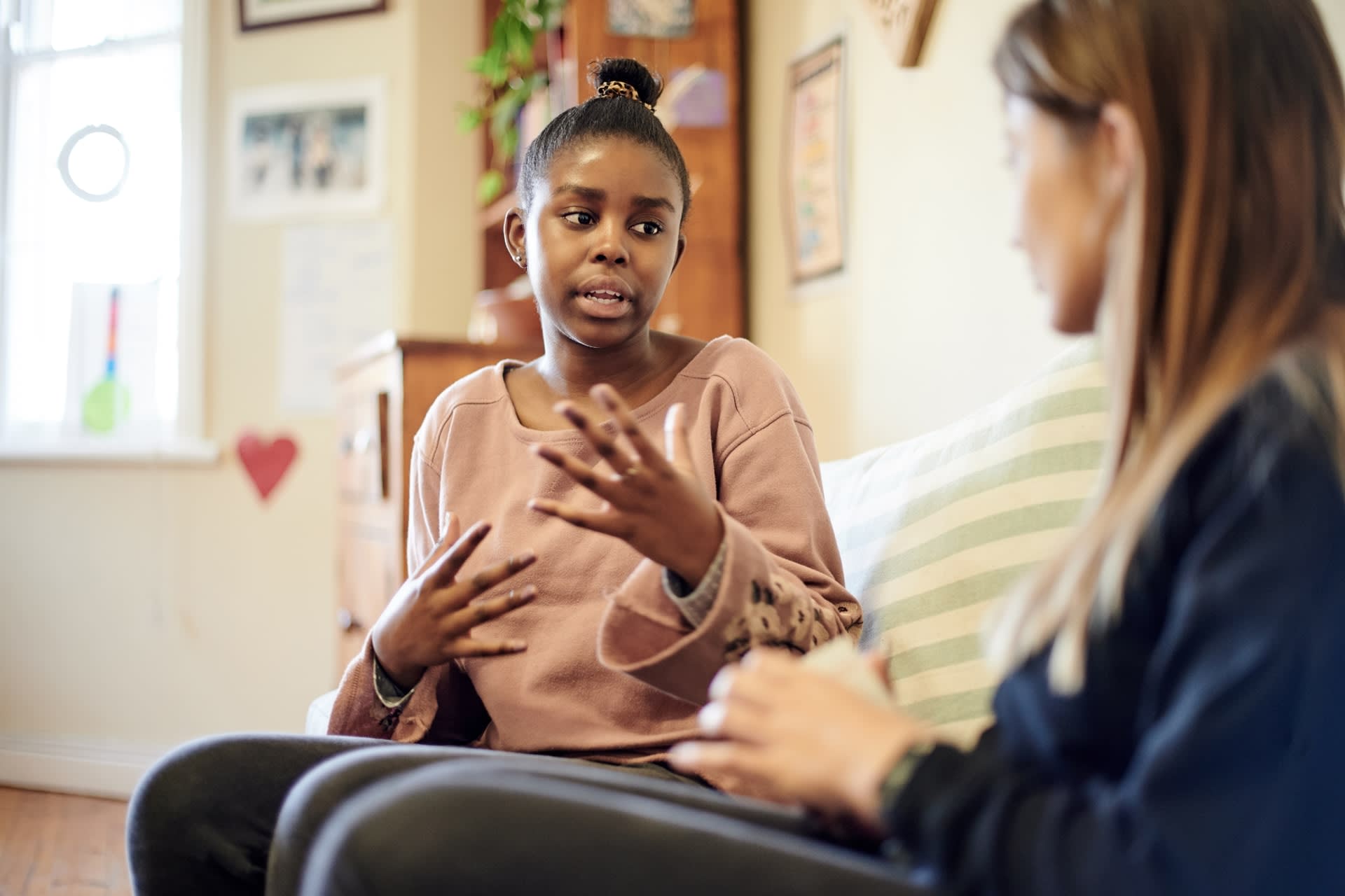african american woman in orange shirt in counseling session 800